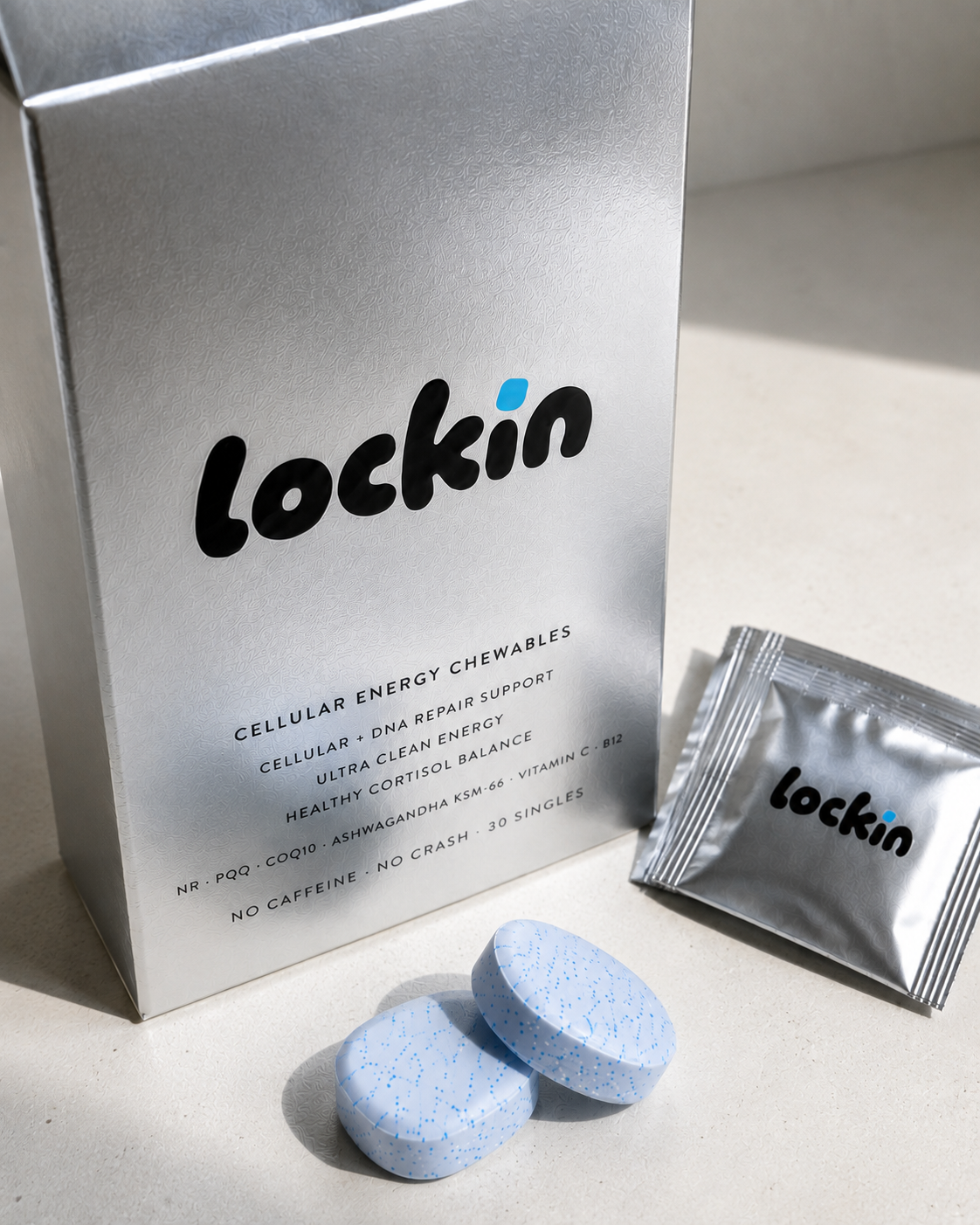 The lockin box at an angle with a foil sachet and two chewables